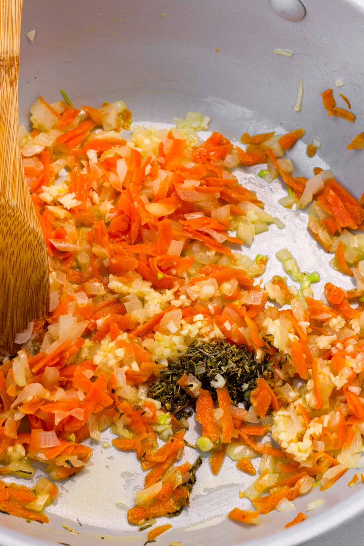 sauteeing carrots, garlic, aromatics in pan