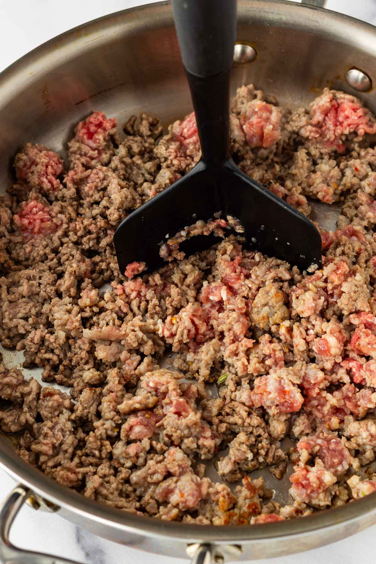 cooking ground beef and italian sausage in skillet
