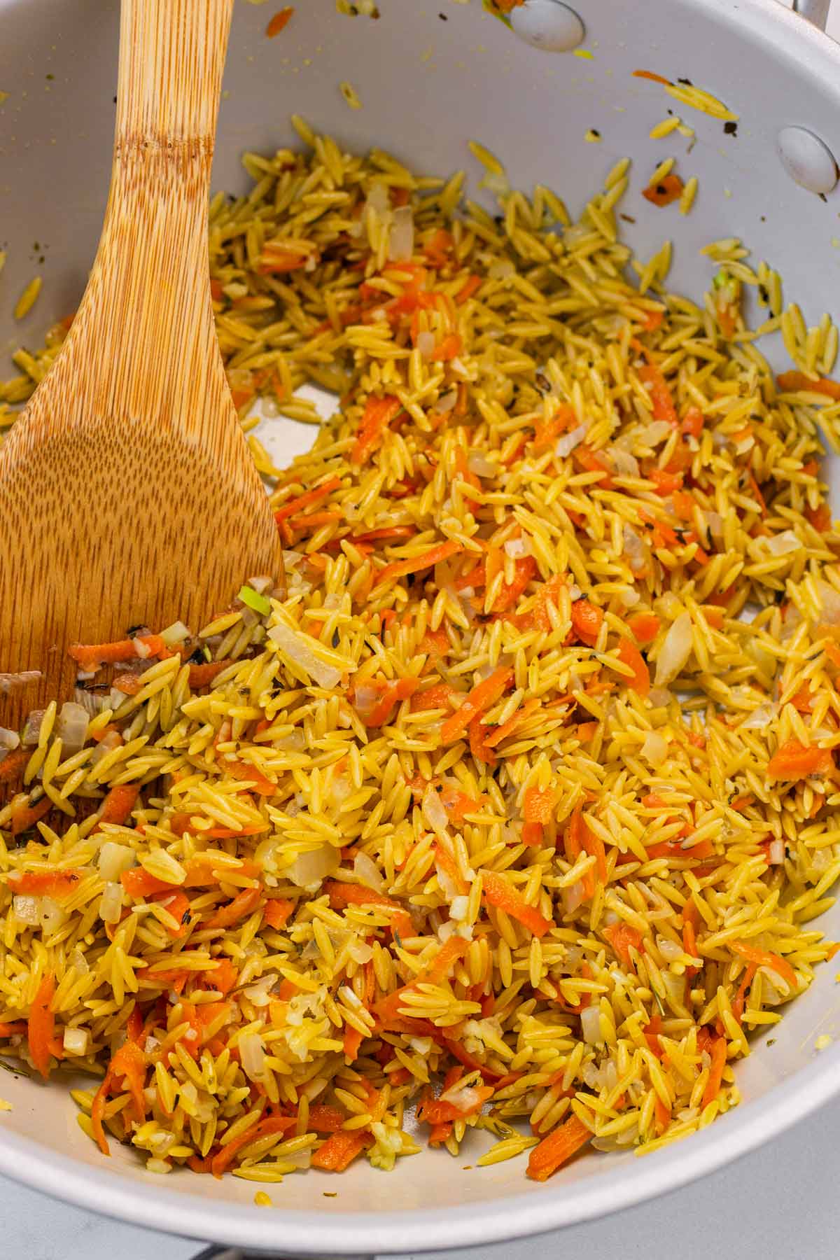 adding orzo to the pan