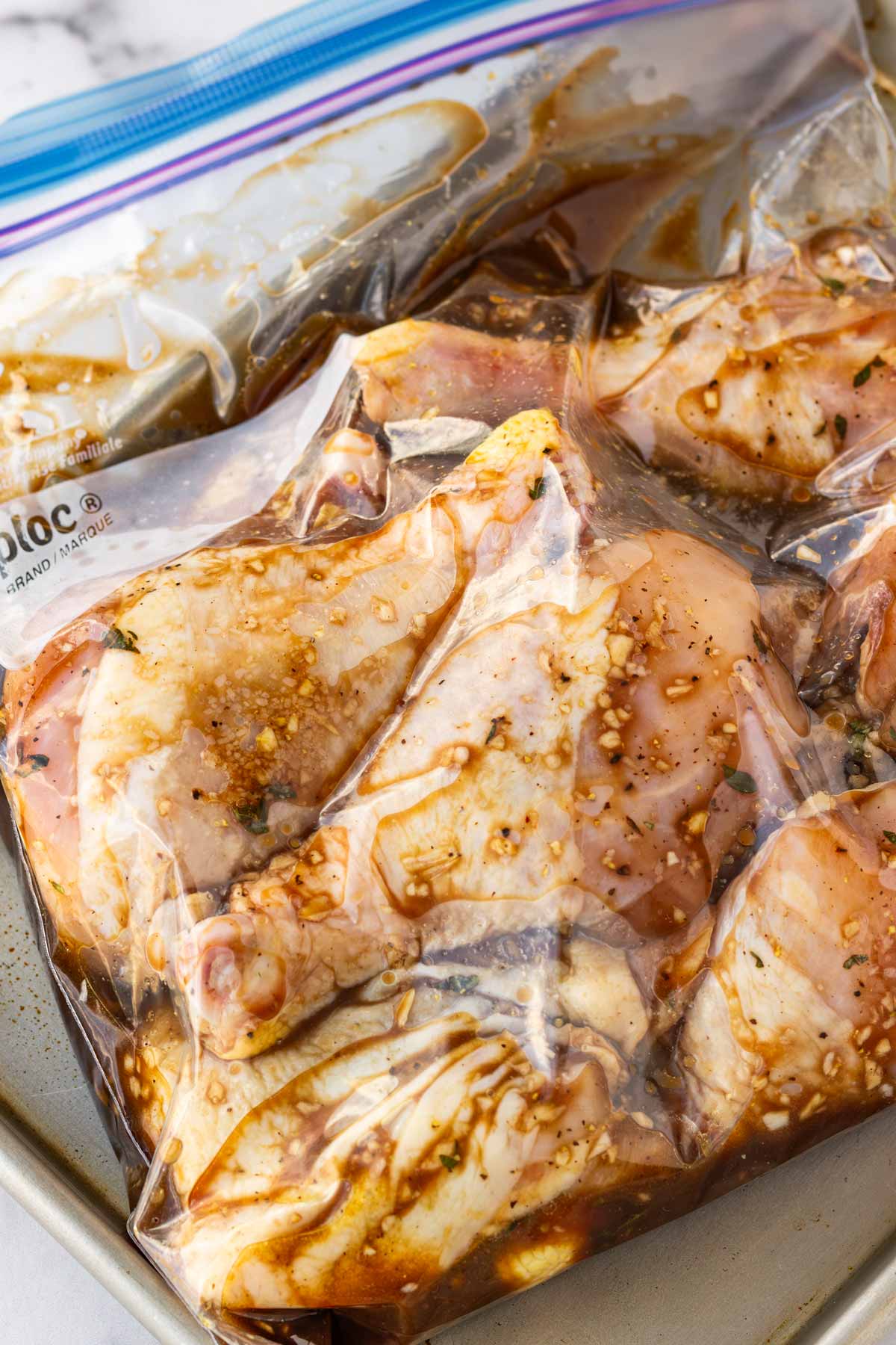 chicken marinating in a resealable bag