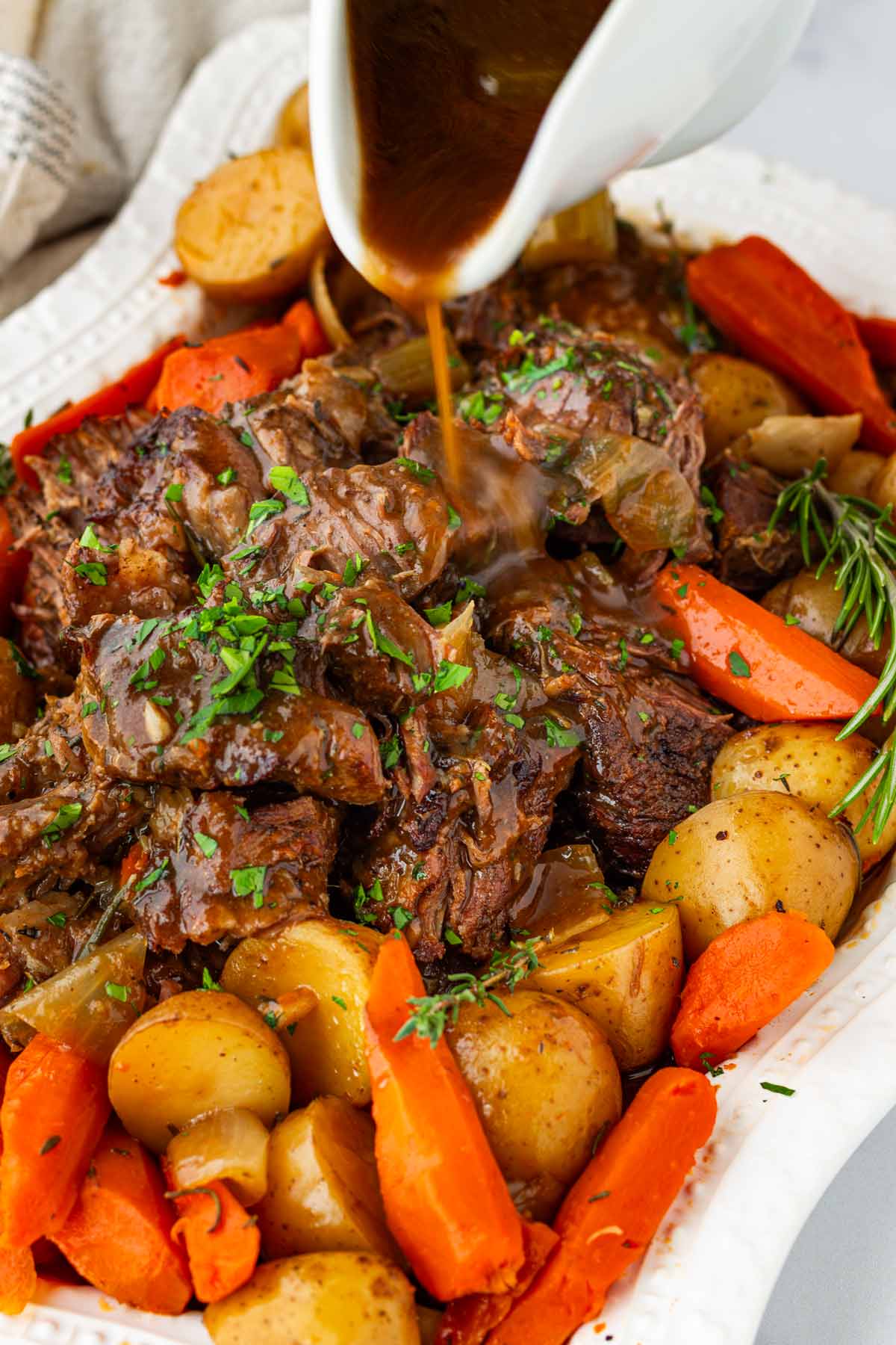 serving the pot roast in a platter with gravy