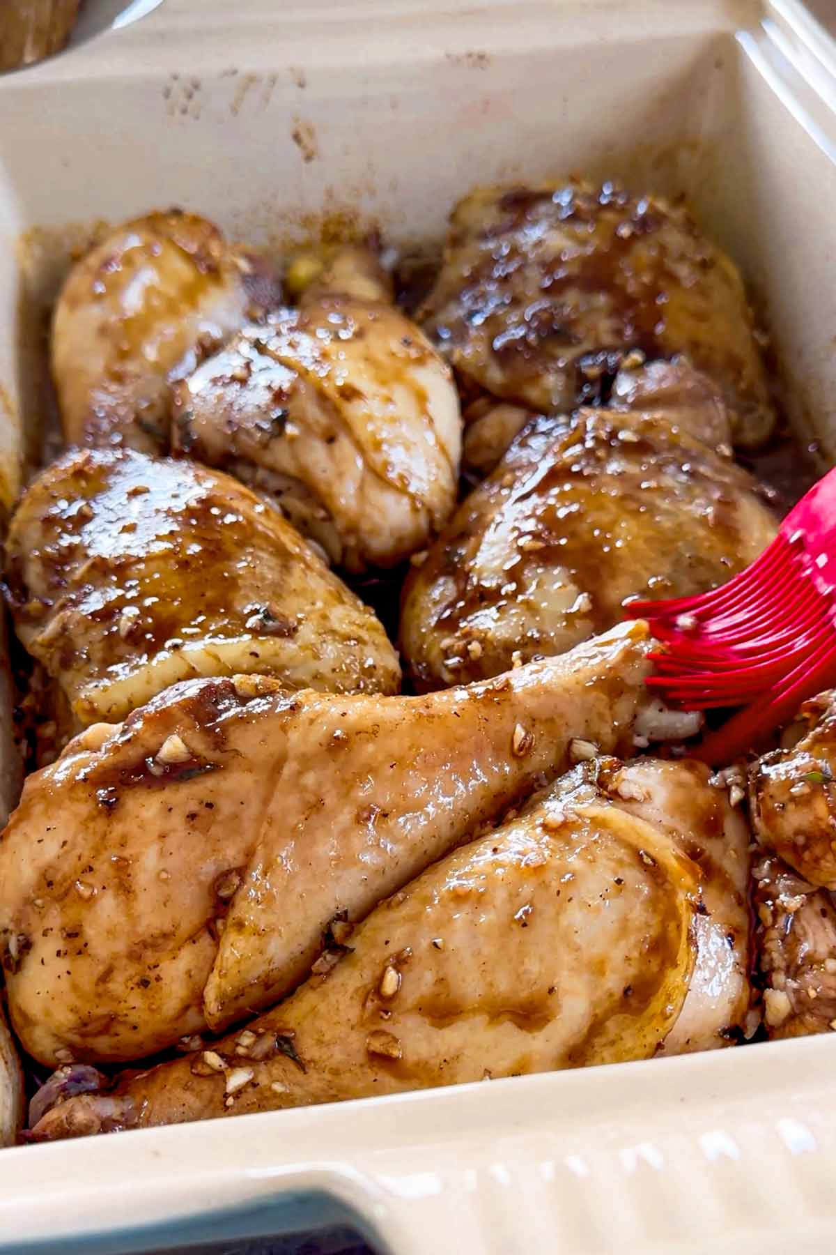 brushing chicken with glaze