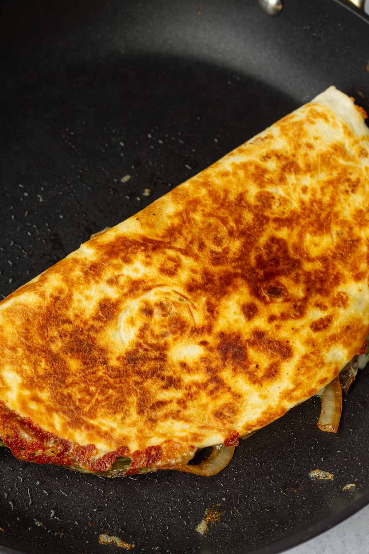 folded golden brown quesadilla on pan