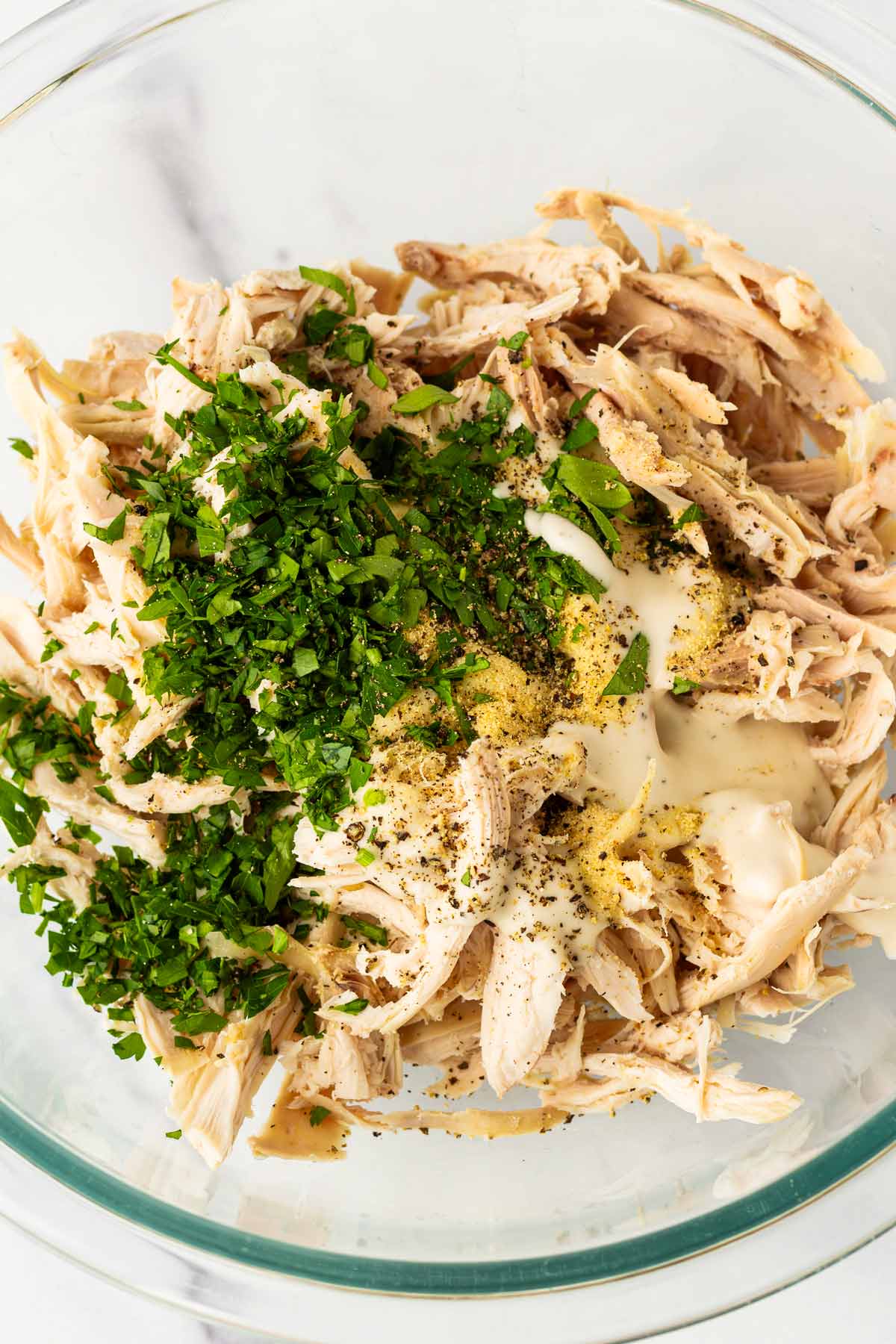 chicken mixture in bowl with ranch, herbs, garlic powder