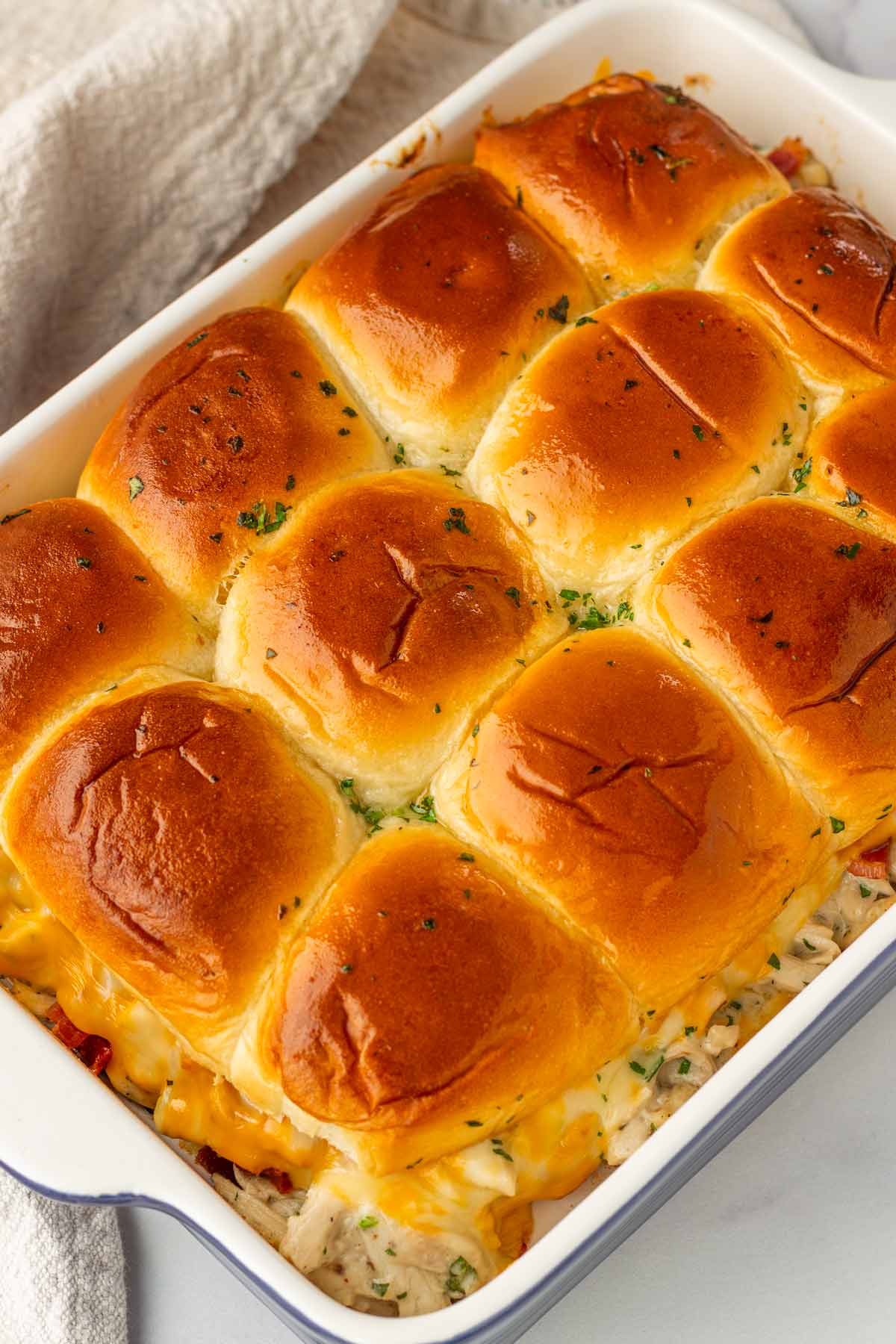 finished baked golden brown chicken bacon ranch sliders in ceramic pan