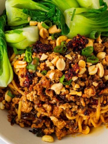 bowl of authentic dan dan noodles with boy choy