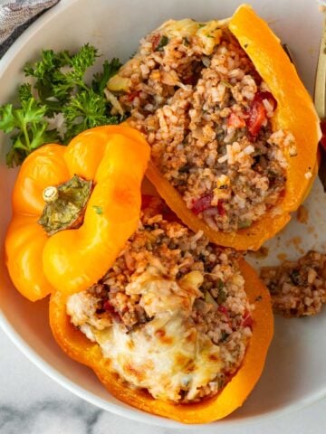cheesy stuffed peppers with rice and ground beef cut open