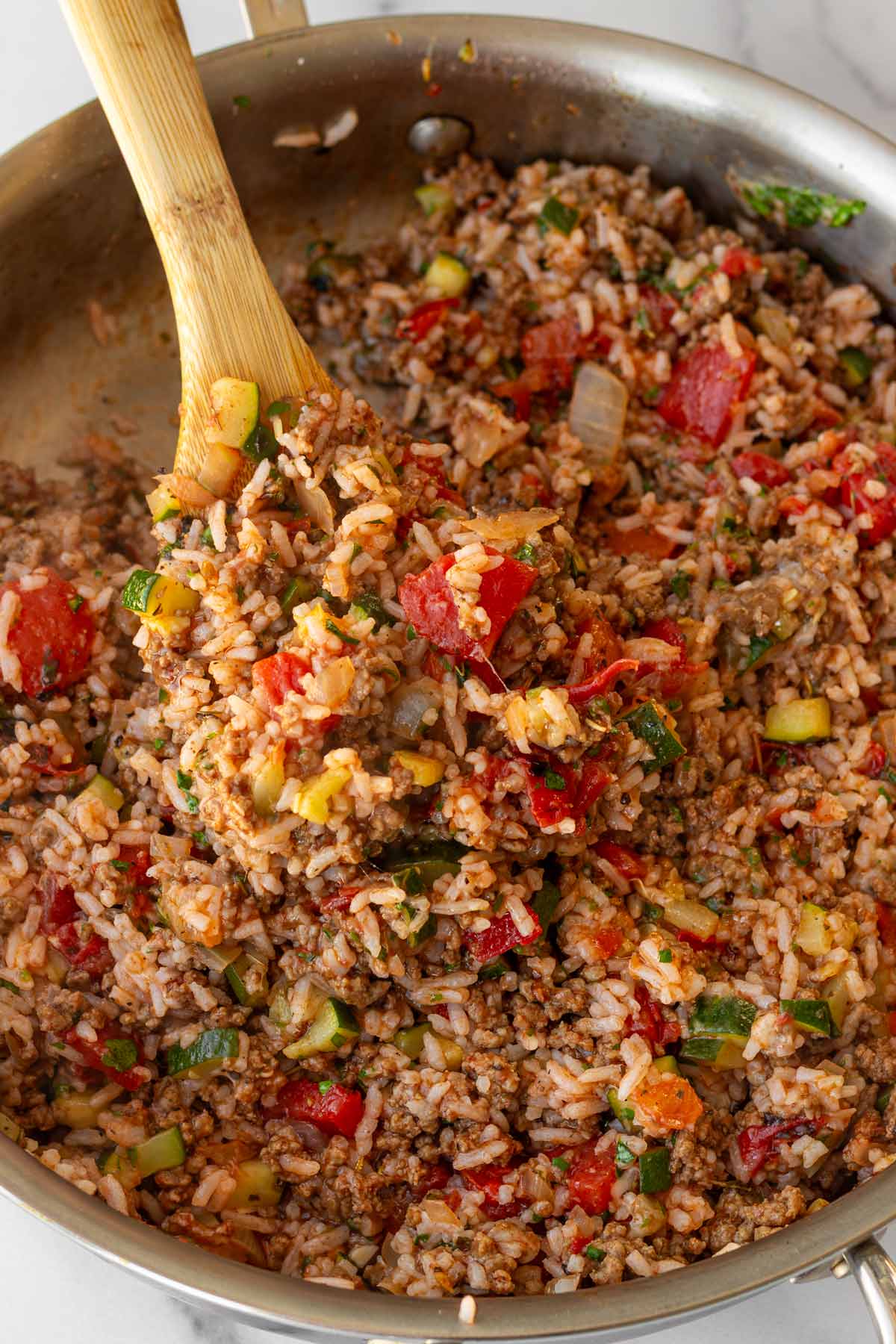 the finished stuffed peppers filling made with rice, beef, and zucchini in a skillet