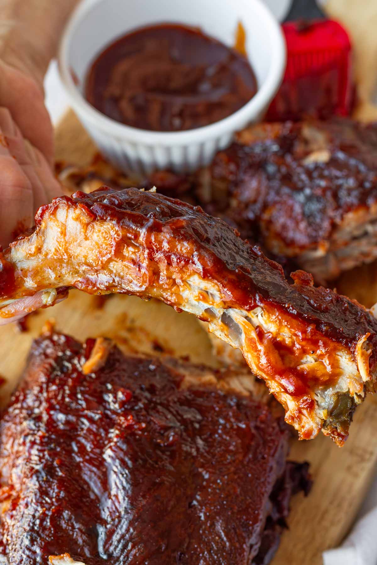 holding a piece of rib