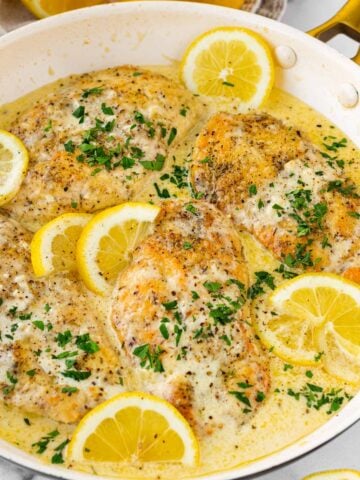 one pan creamy lemon chicken with lemon slices as garnish