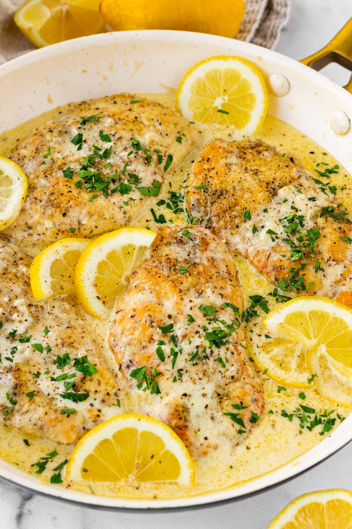 one pan creamy lemon chicken with lemon slices as garnish