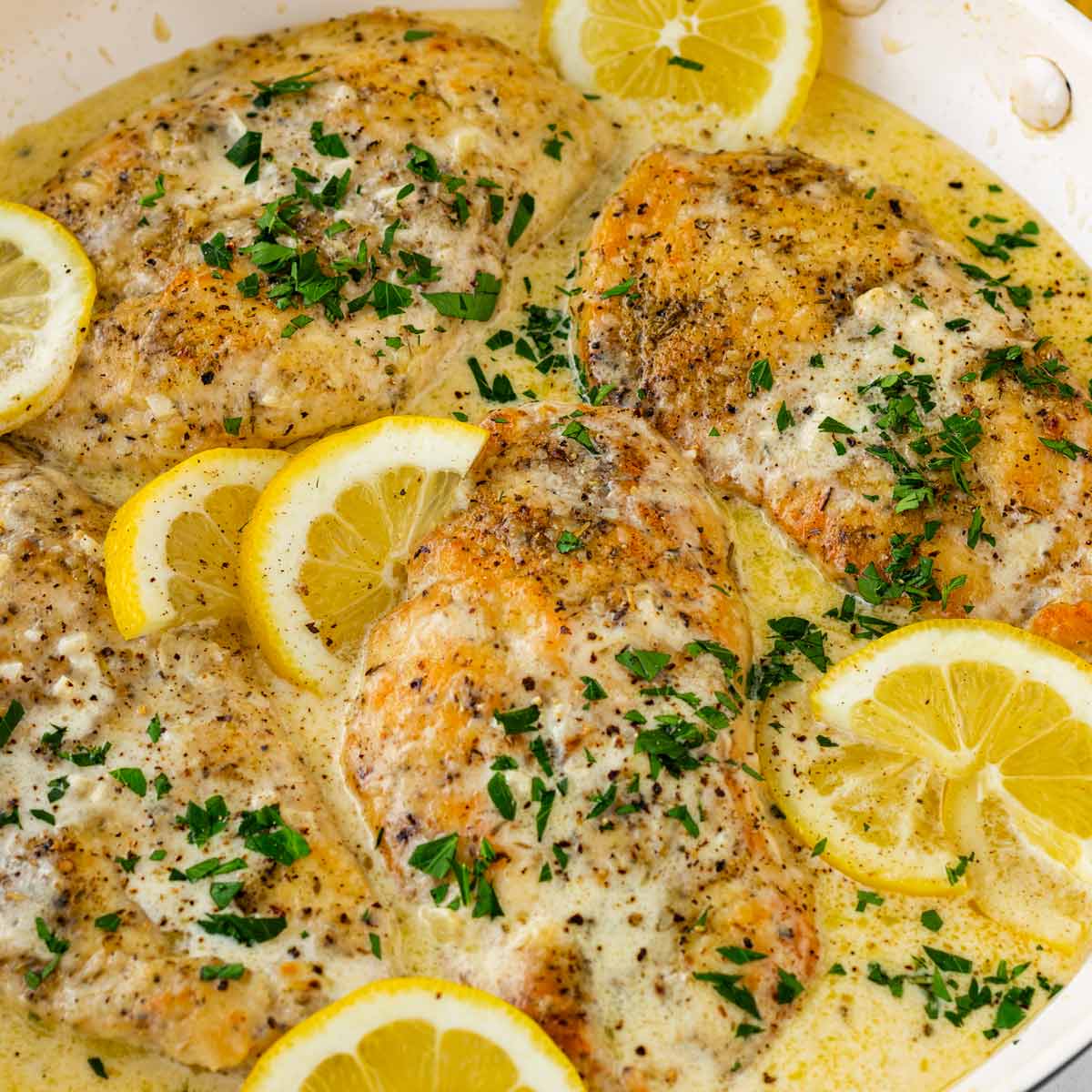 creamy lemon chicken in one skillet with fresh lemons