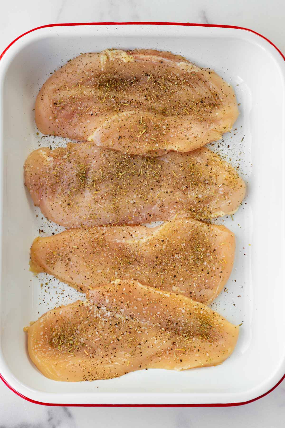 seasoned chicken cutlets in a pan