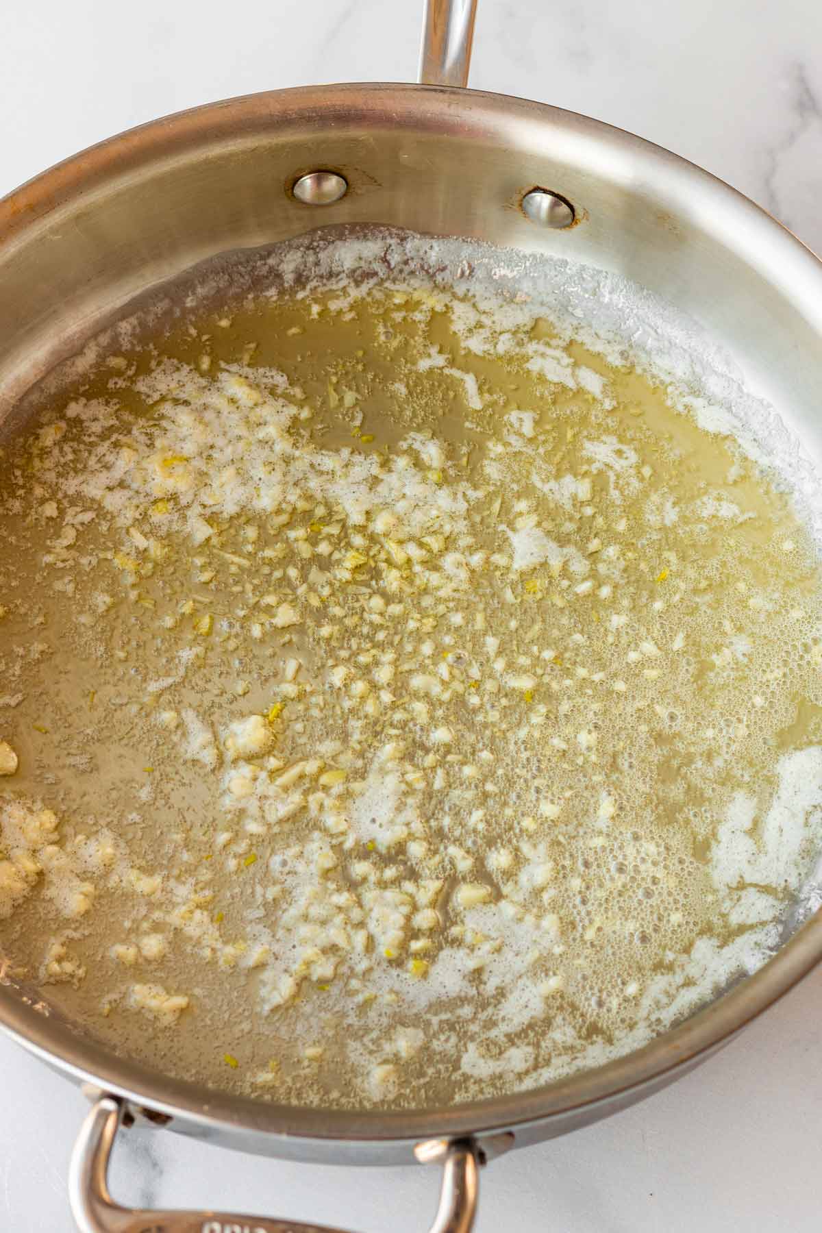 sauteing garlic in butter in skillet