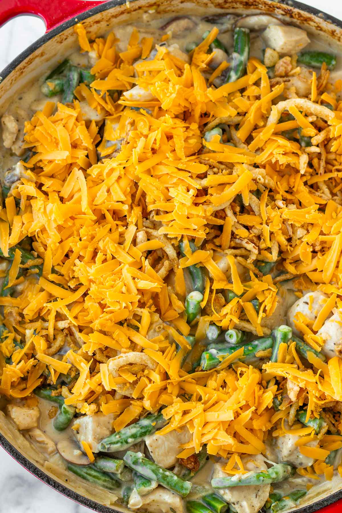 casserole topped with shredded cheese and onions
