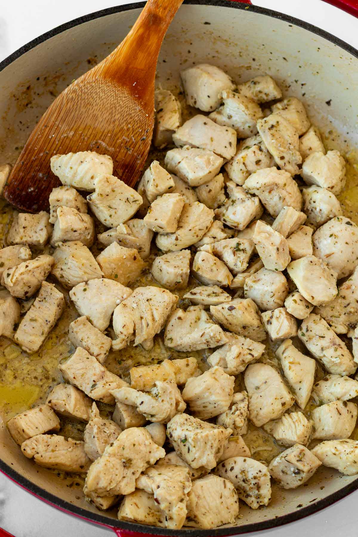 cooking seasoning chicken in the pan