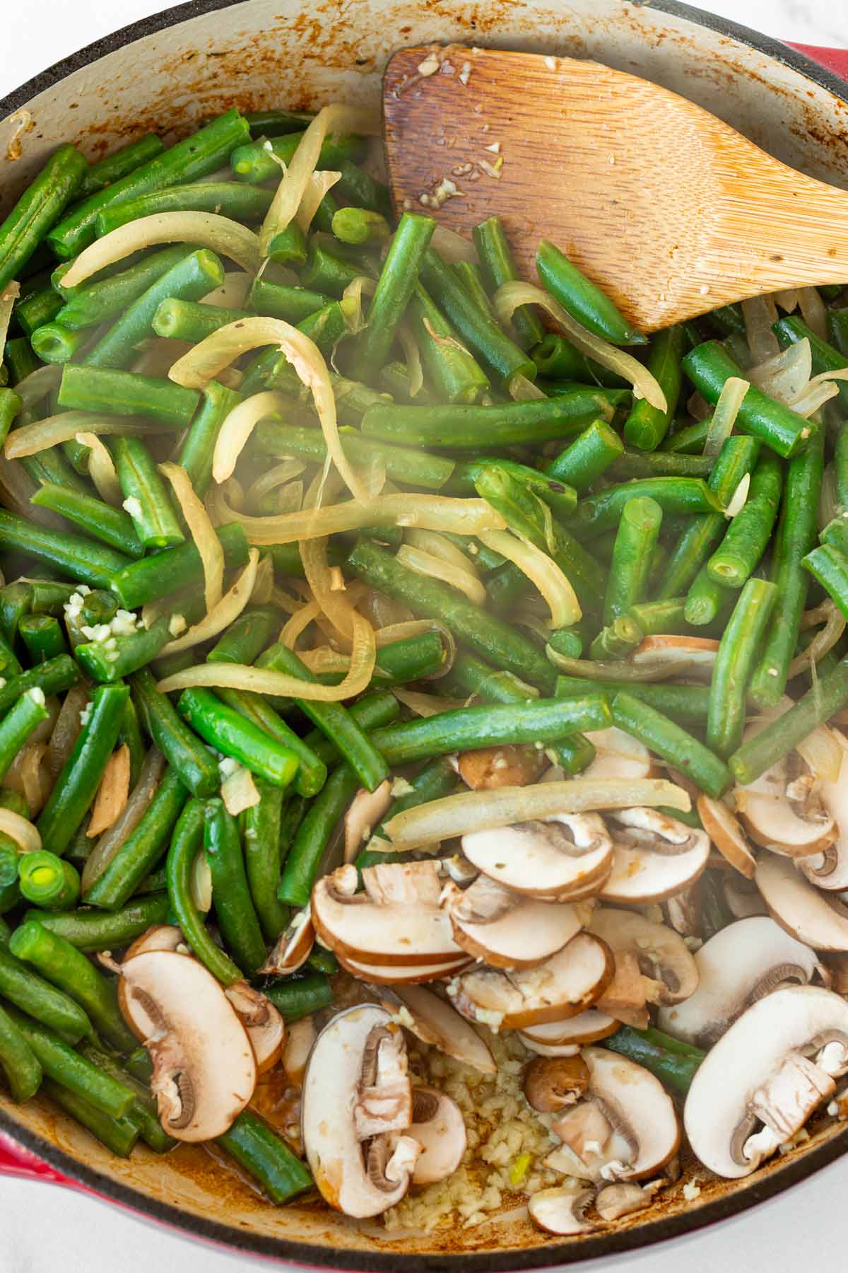 sauteing green beans, onions, mushrooms, garlic in a deep pan