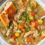hearty chicken stew in bowl with bread