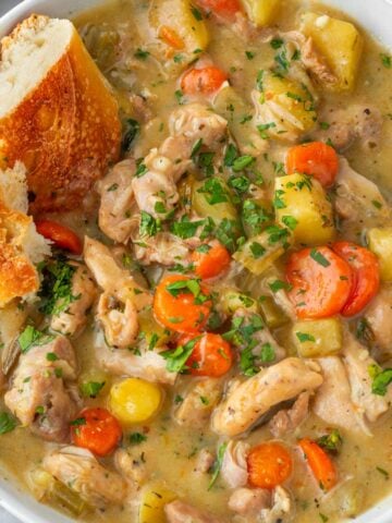 hearty chicken stew in bowl with bread