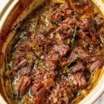 broiled caramelized shredded chuck roast in a baking pan