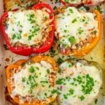 ground turkey stuffed peppers with rice and cheese in a baking pan