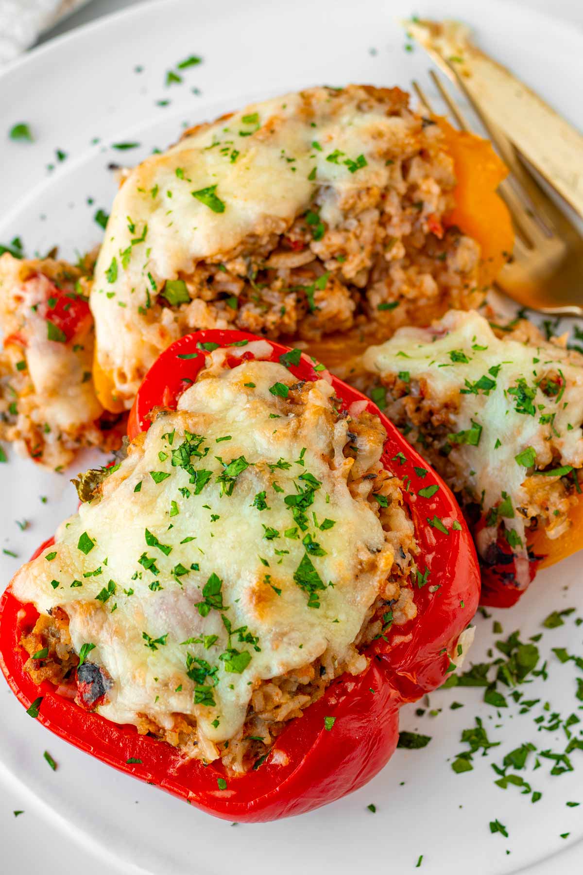 two individual stuffed peppers cut on a plate