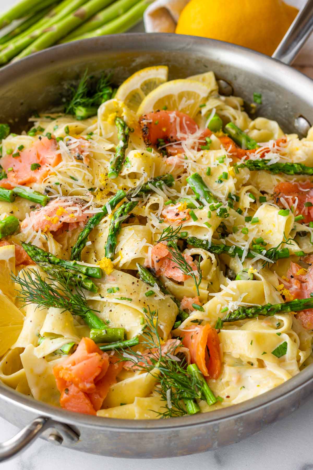 stainless skillet with creamy smoked salmon pasta, herbs, and dill