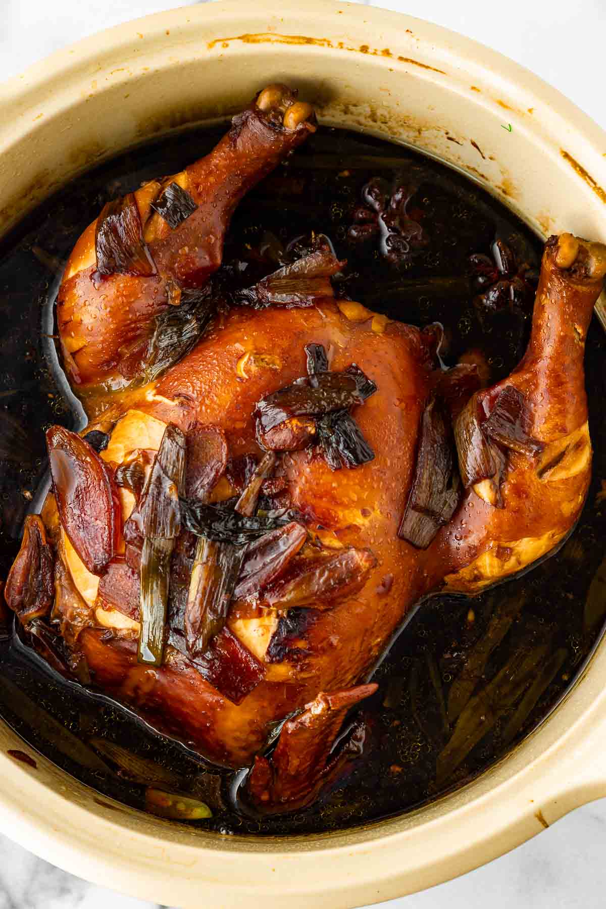 basted chinese soy sauce chicken in soy broth with aromatics