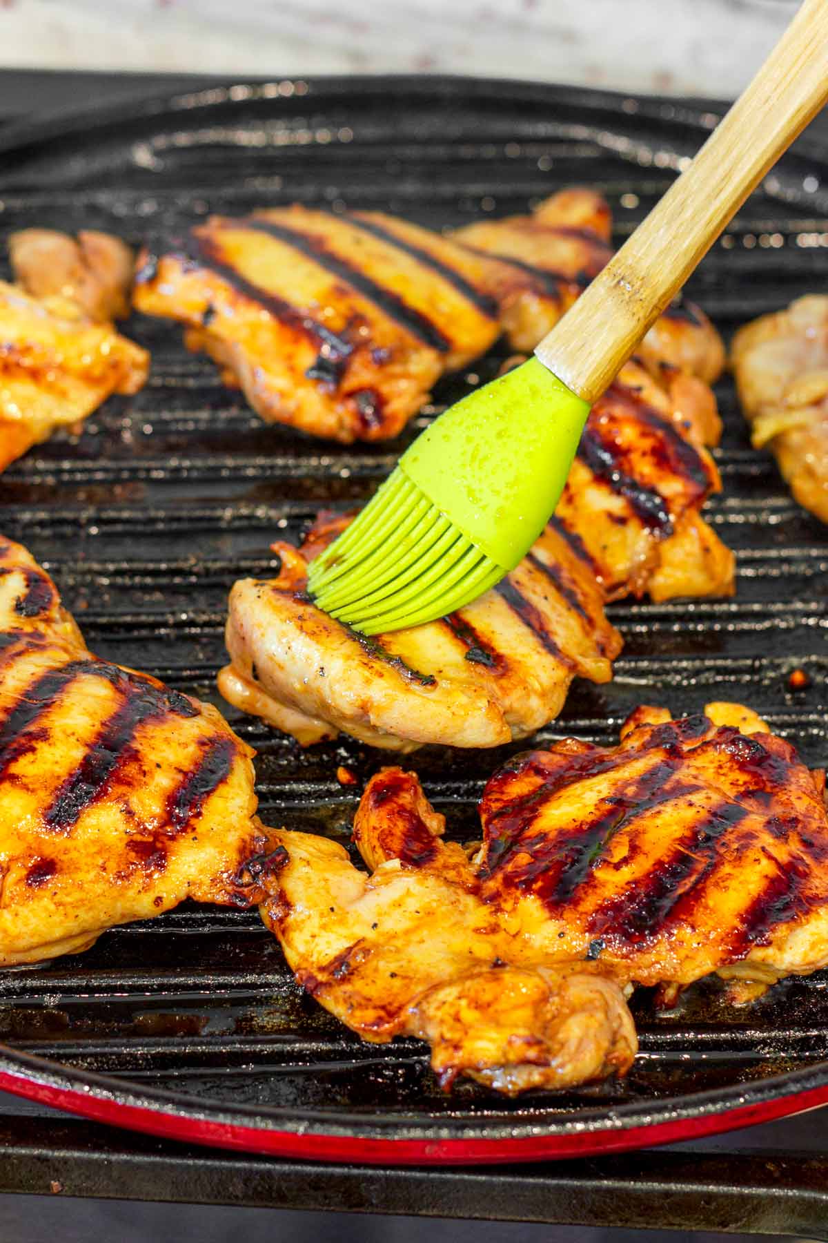 brushing chicken with the glaze