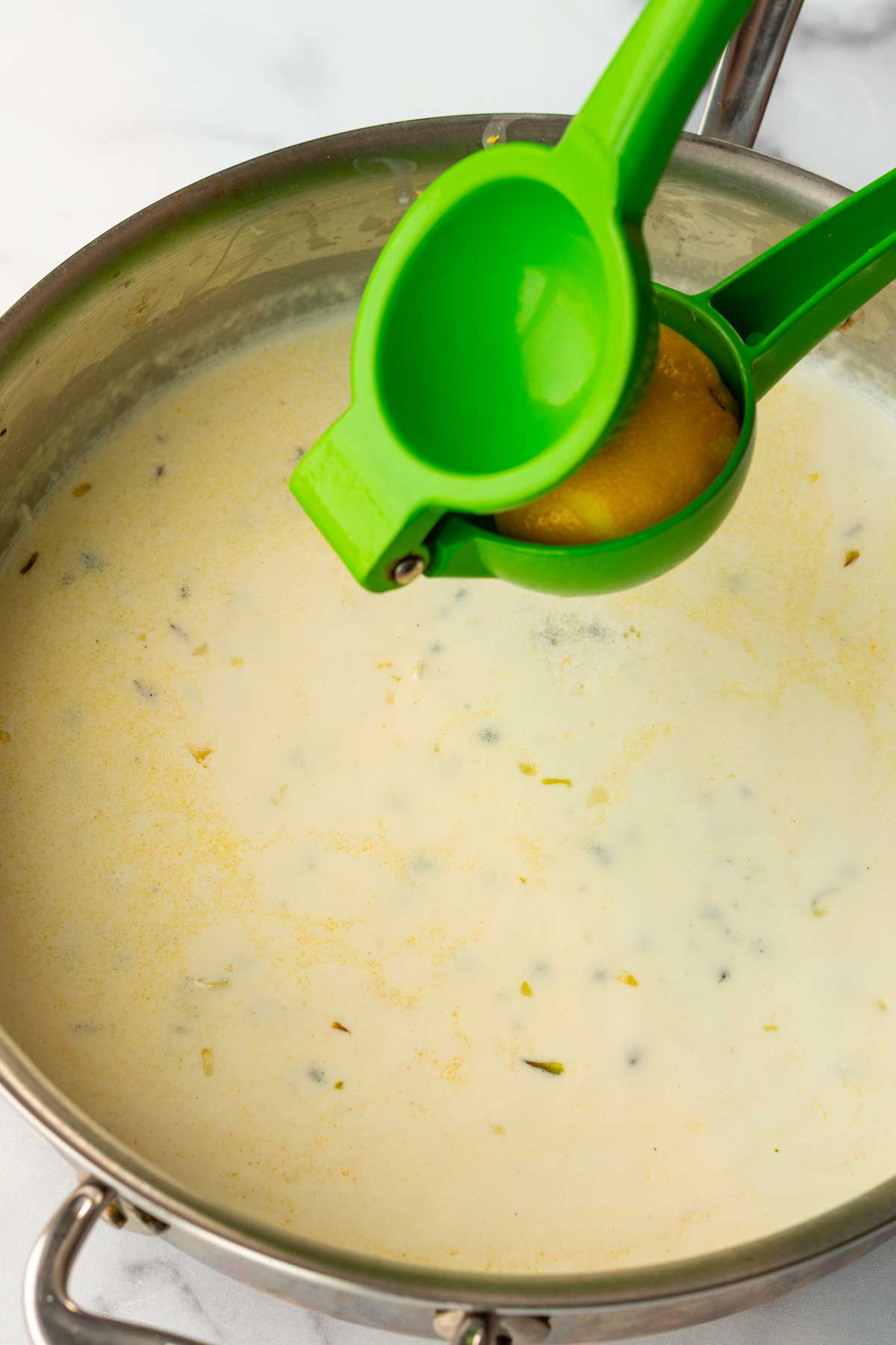 squeezing lemon juice into the cream