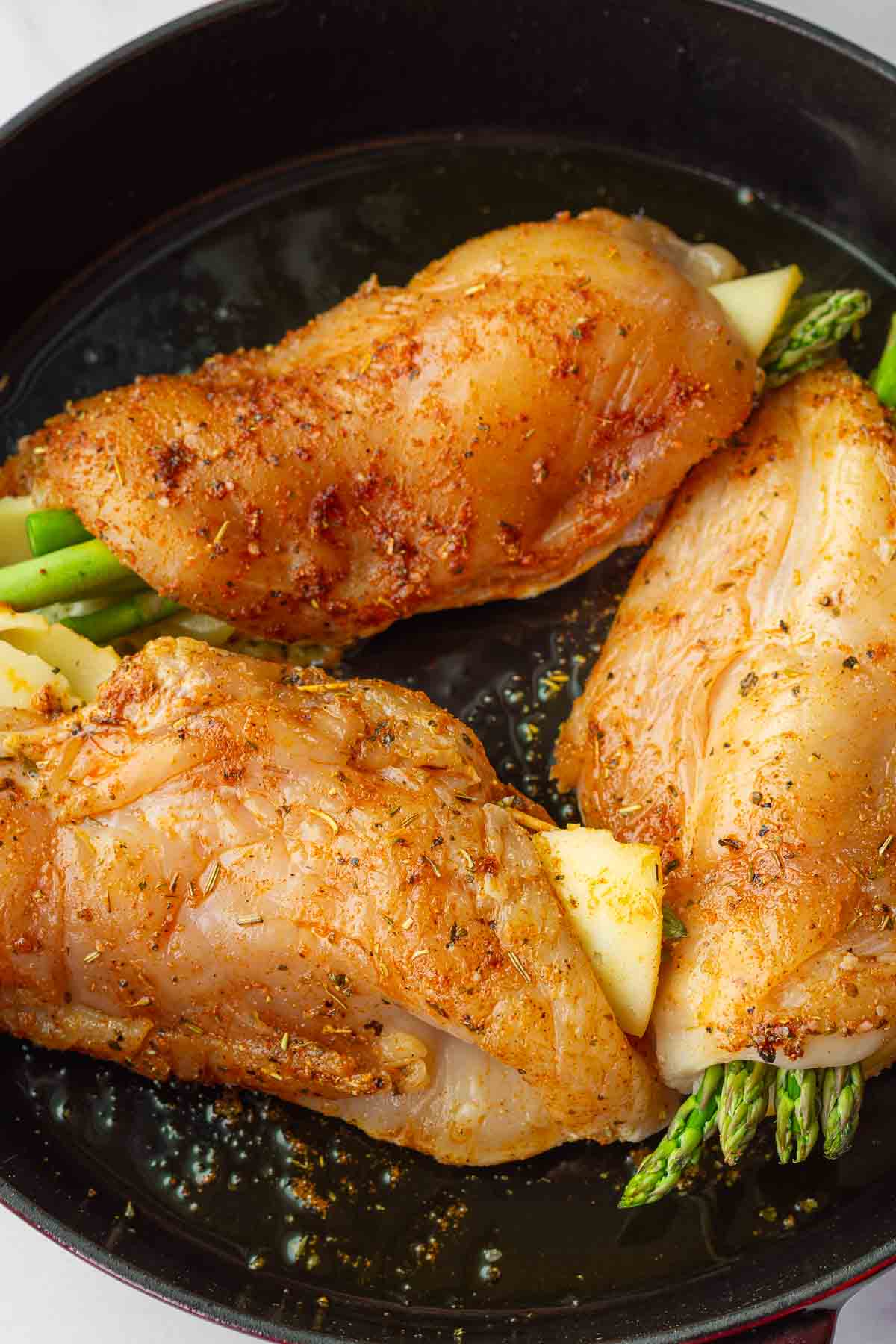 searing chicken in a cast iron pan