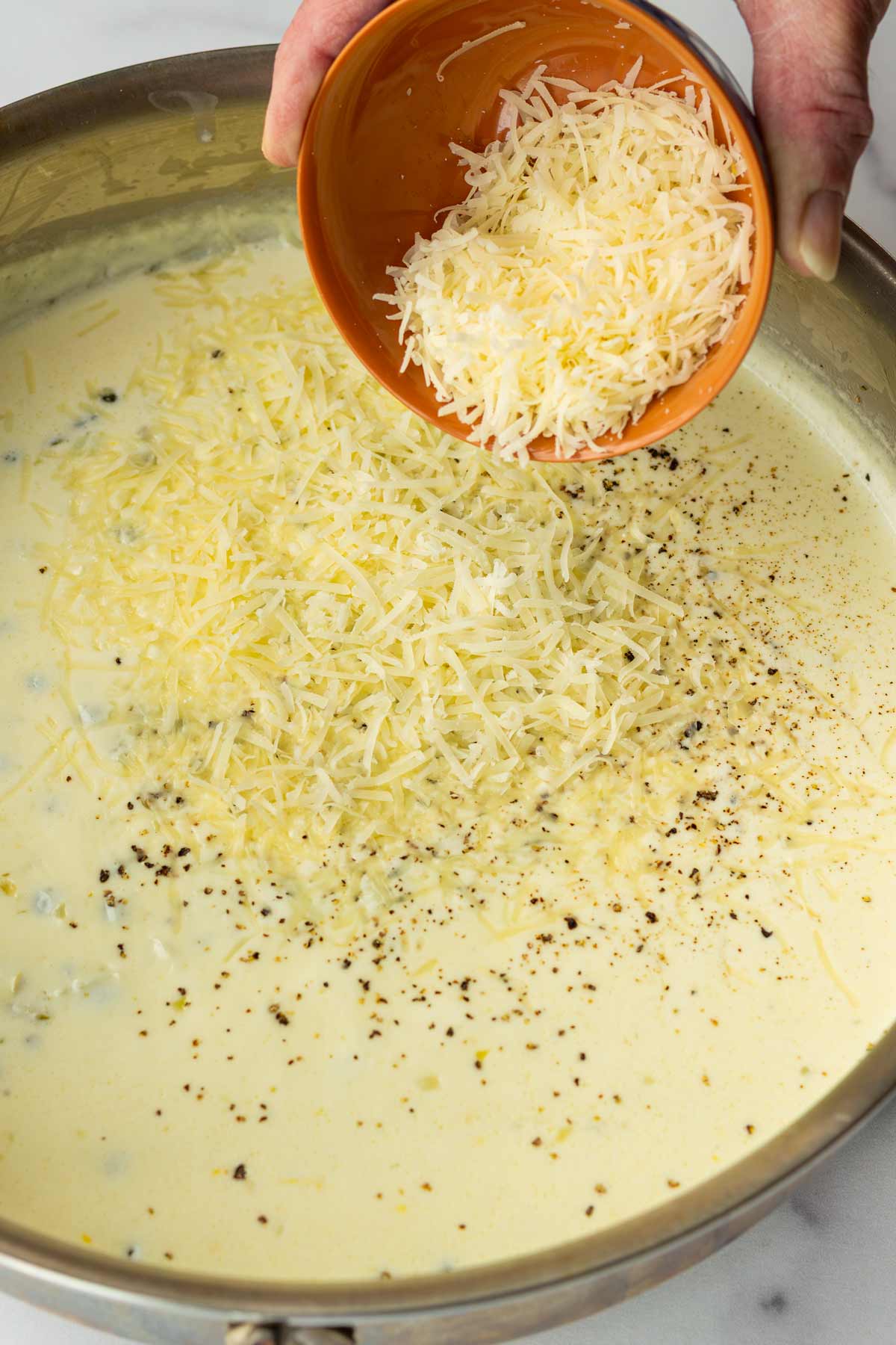 adding grated parmesan in the sauce