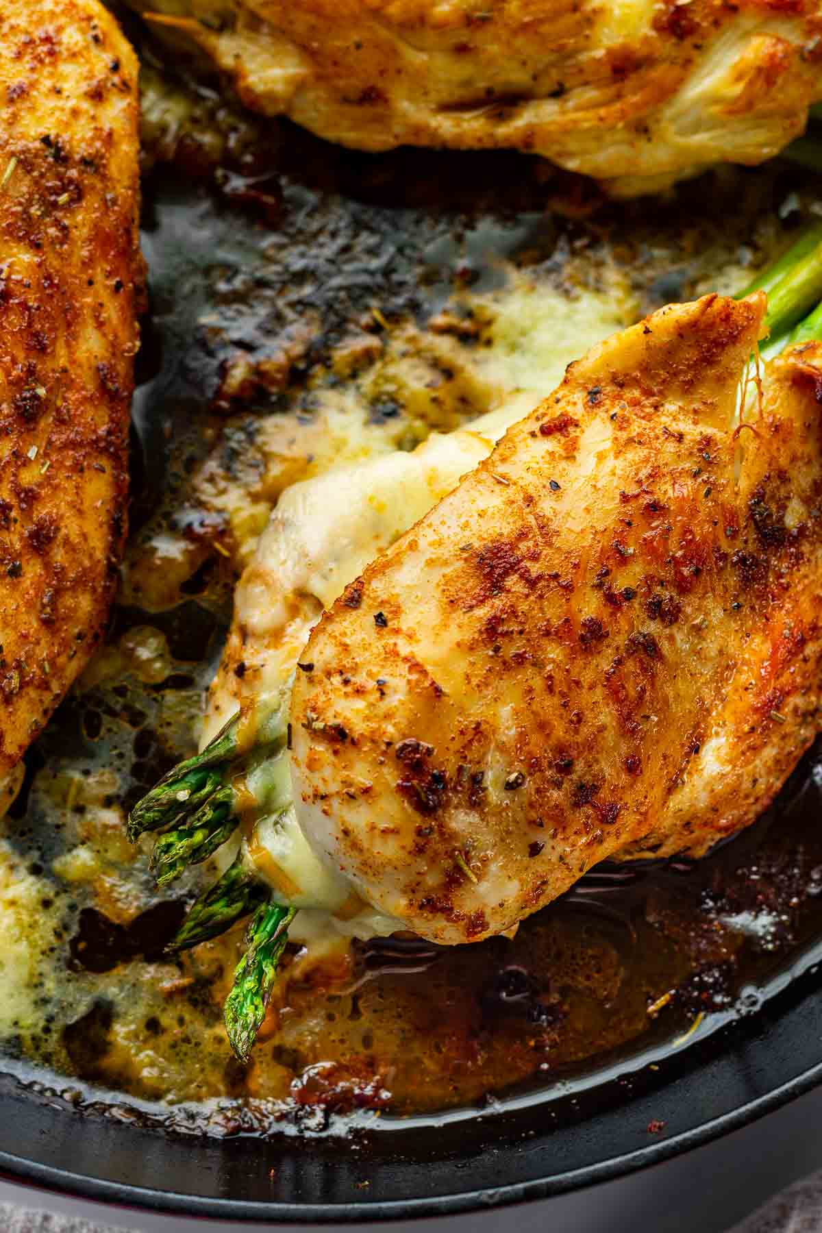 seared golden stuffed chicken breast in cast iron pan