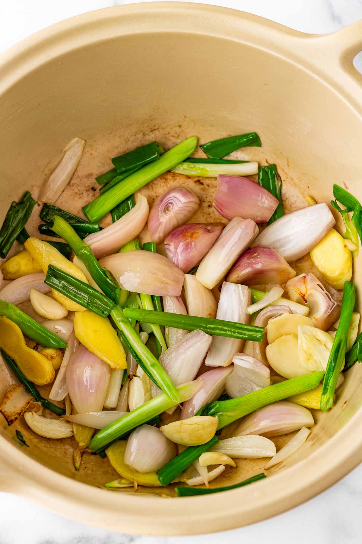 sauteing aromatics like garlic, ginger, scallions in a deep dutch oven pot