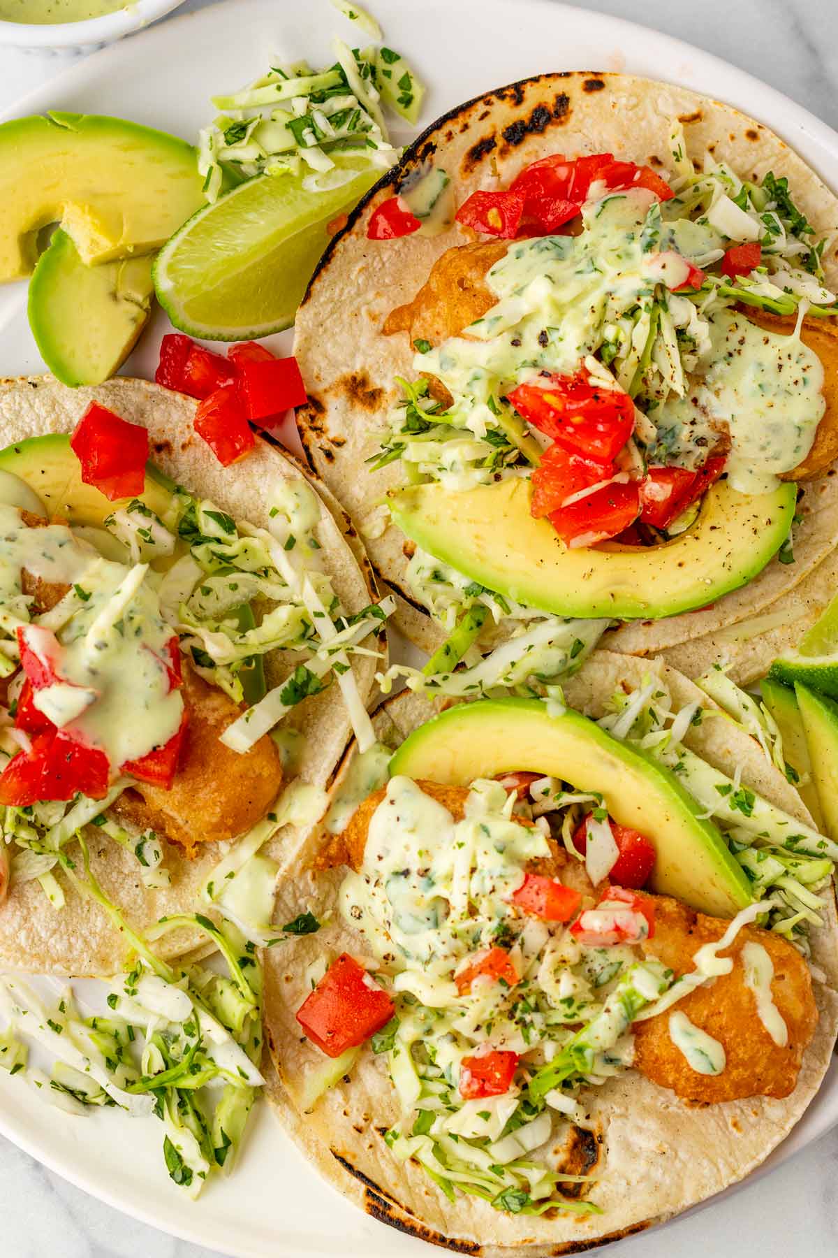 three servings of baja fish tacos fried with beer batter