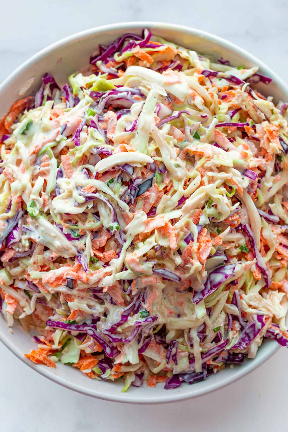 creamy coleslaw with green and purple cabbage and carrots