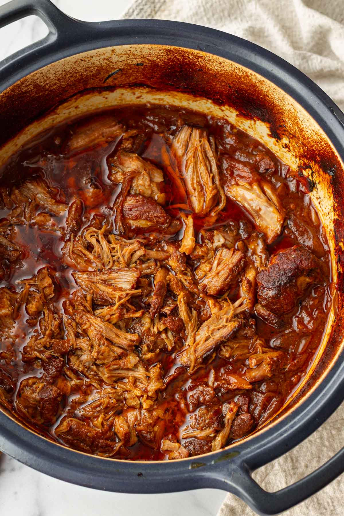 pulled pork cooked in a blue dutch oven