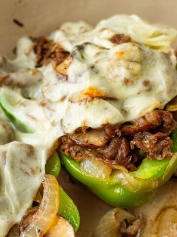 Philly cheesesteak stuffed green bell peppers in pan