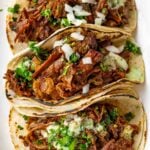 three generously filled shredded beef tacos