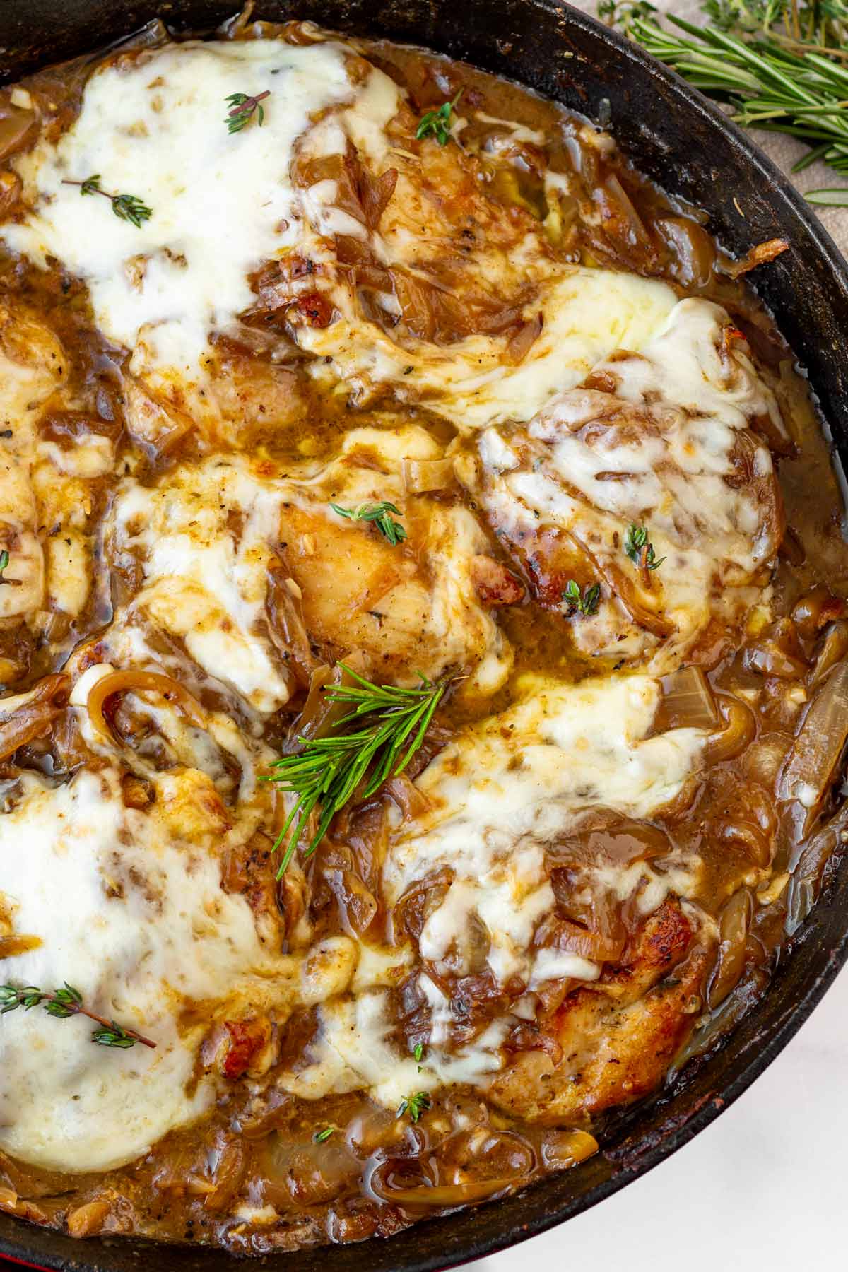 melted french onion chicken in a cast iron skillet