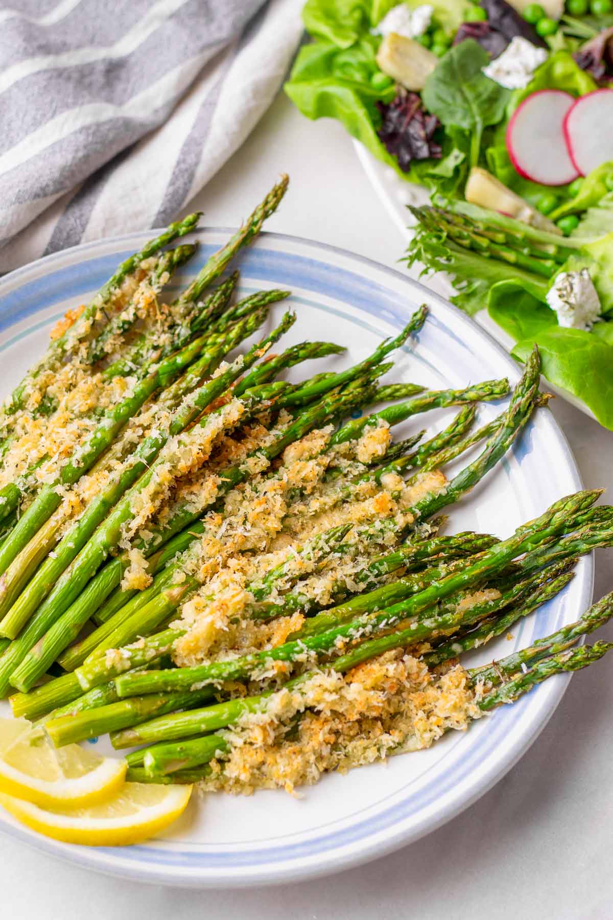 roasted asparagus topped with parmesan and panko breadcrumbs on plate