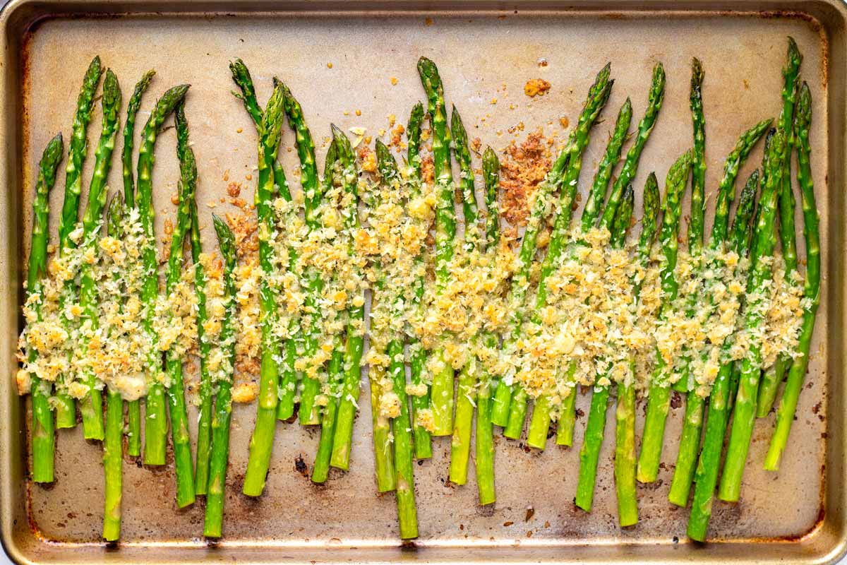 a single layer of roasted asparagus with parmesan and panko on top