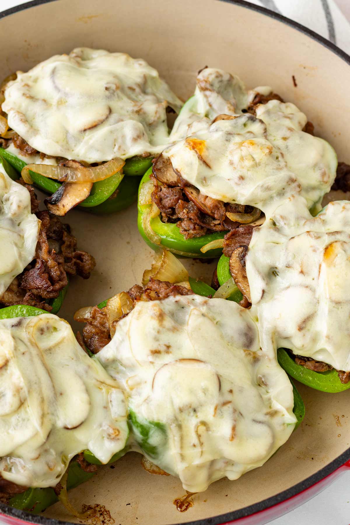 melty cheesesteak stuffed peppers in a dutch oven
