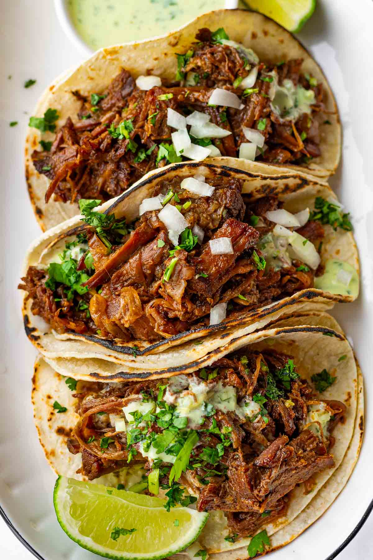 shredded beef tacos piled high with toppings