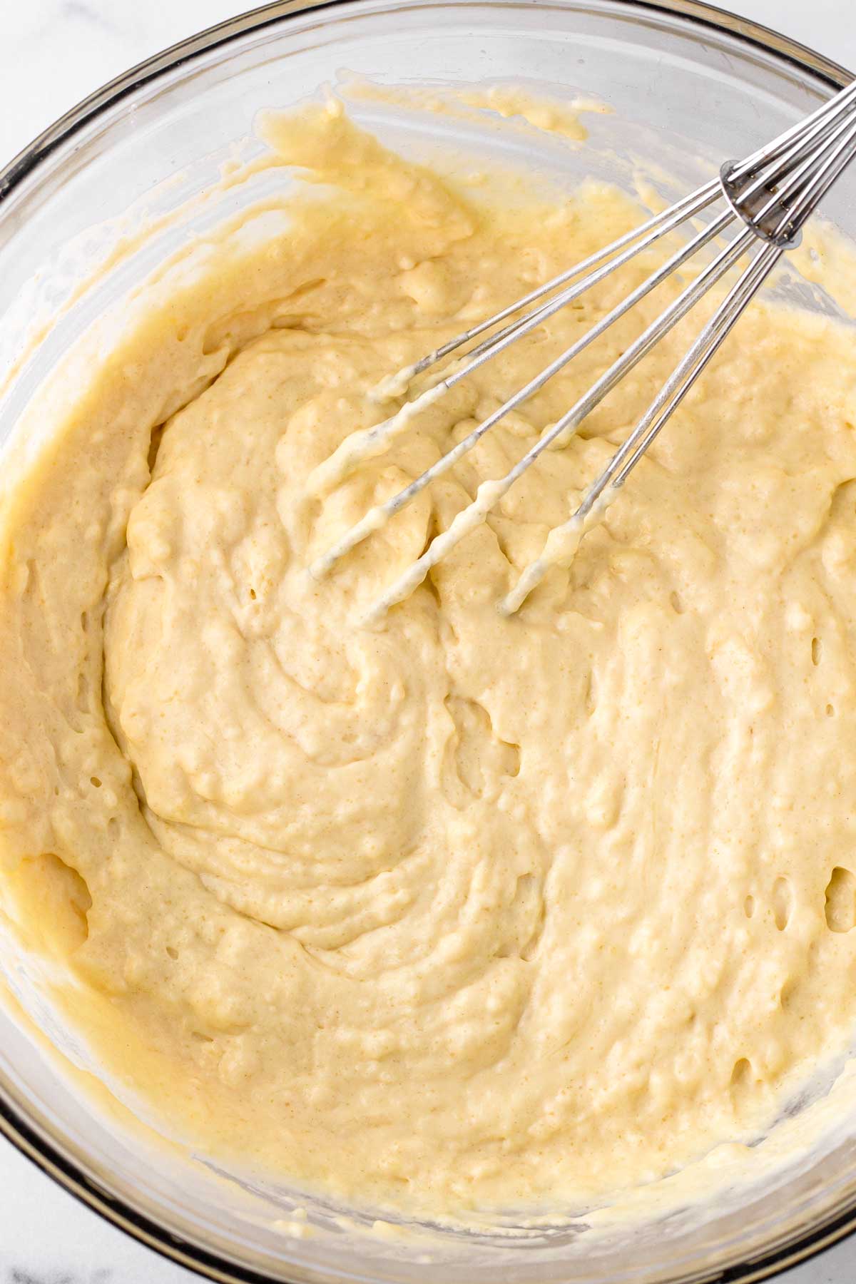 mixing both dry and wet ingredients to make lumpy batter