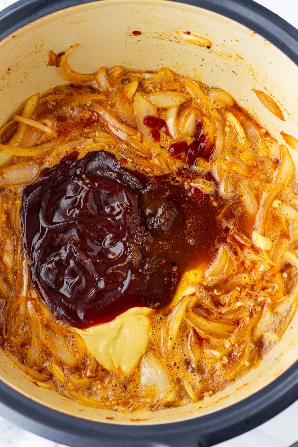 adding bbq sauce, mustard, sugar to form the braising liquid