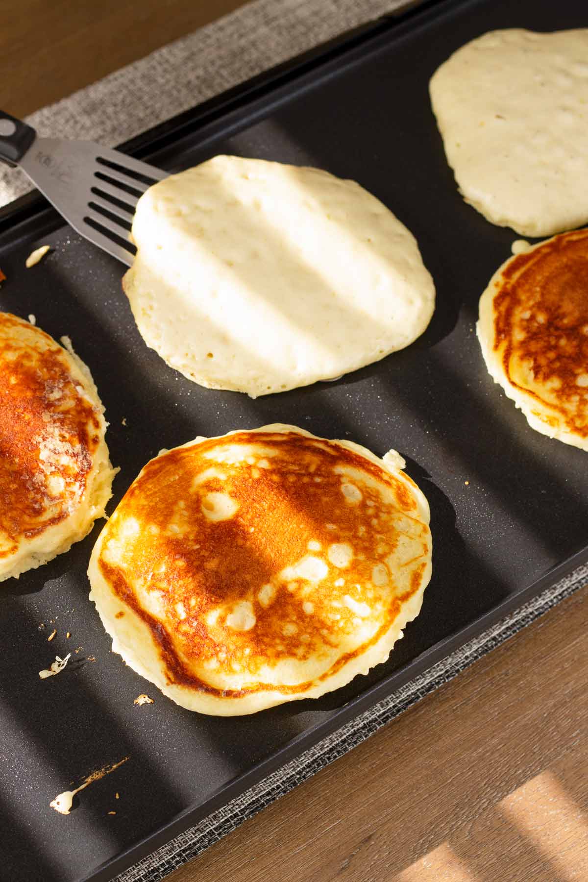 flipping pancakes on the griddle