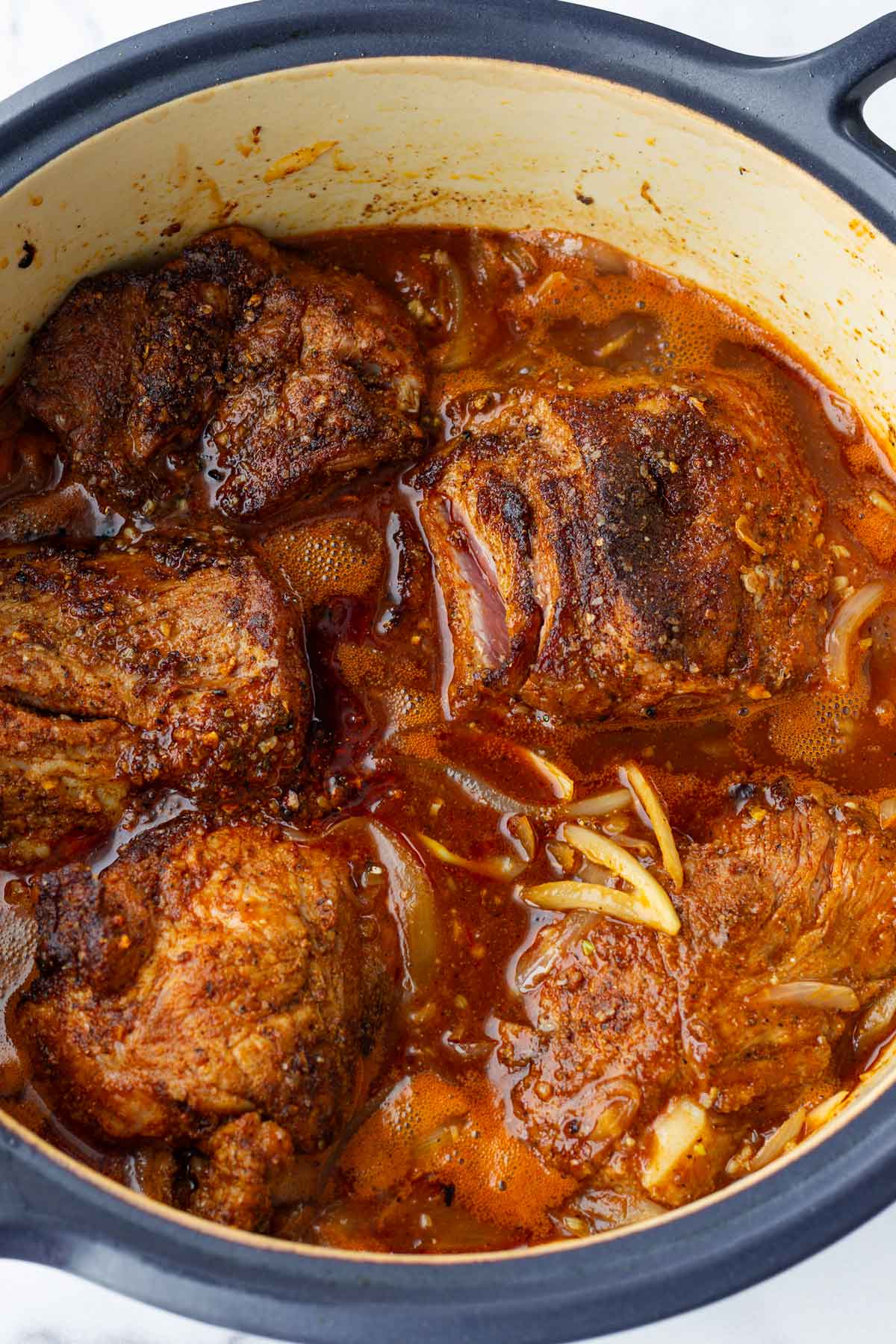 returned the seared pork into the dutch oven with the liquid