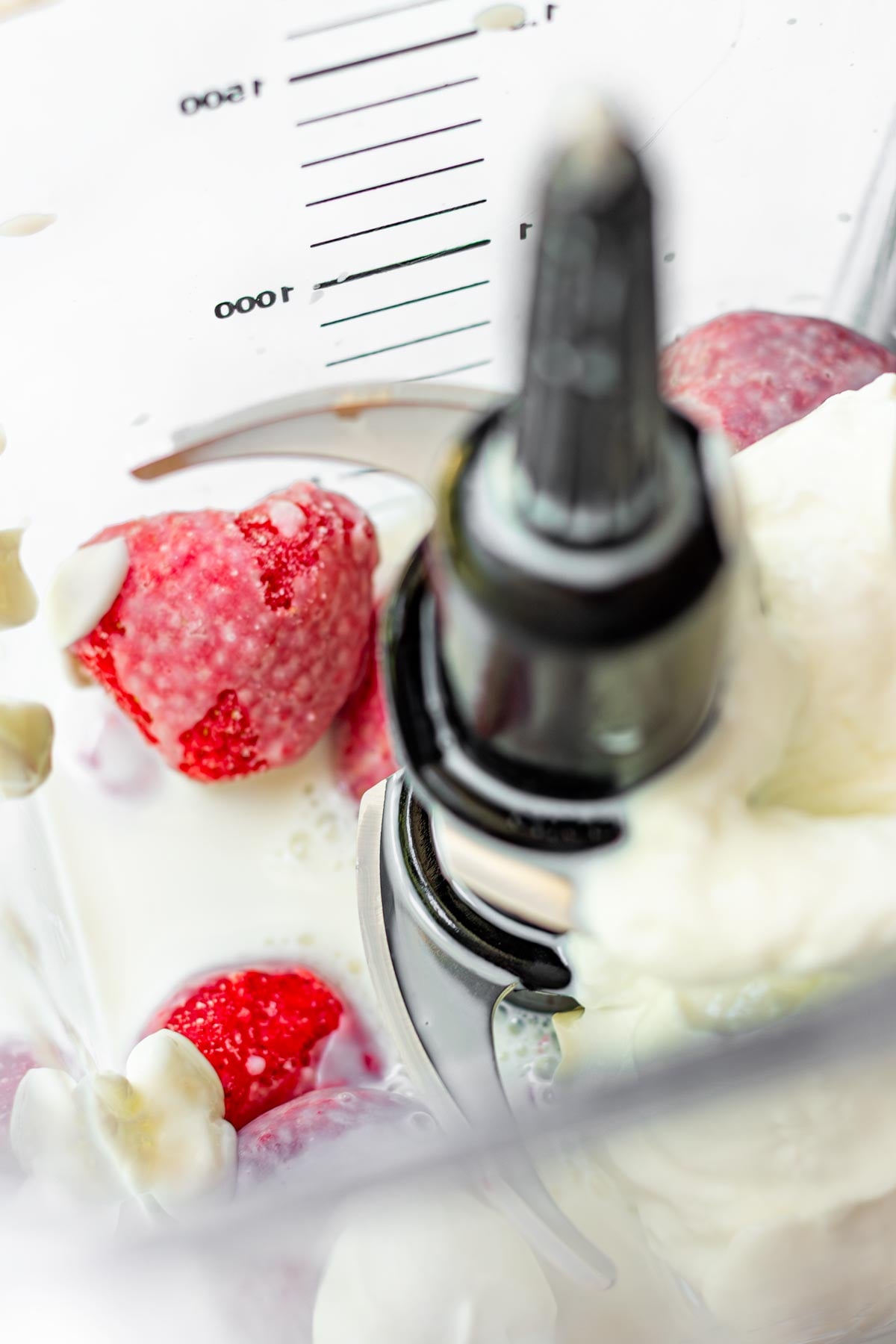 frozen strawberries, yogurt, milk in a blender