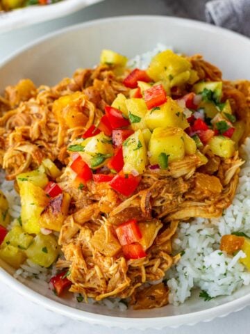 pulled chicken cooked in crockpot over rice and topped with pineapple salsa